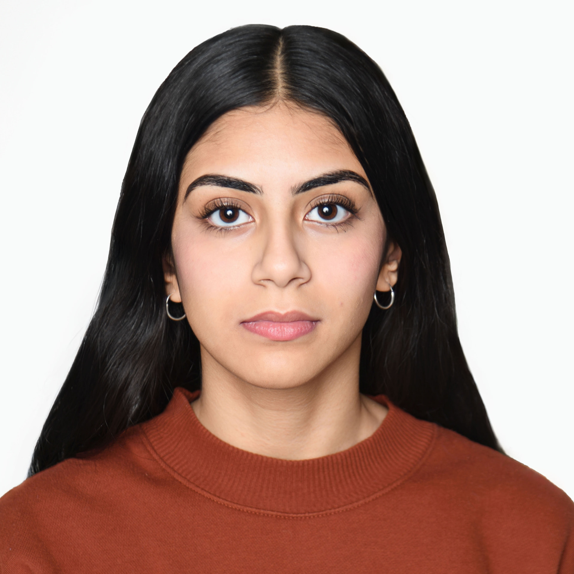 Compliant passport photo of a young woman on a plain background